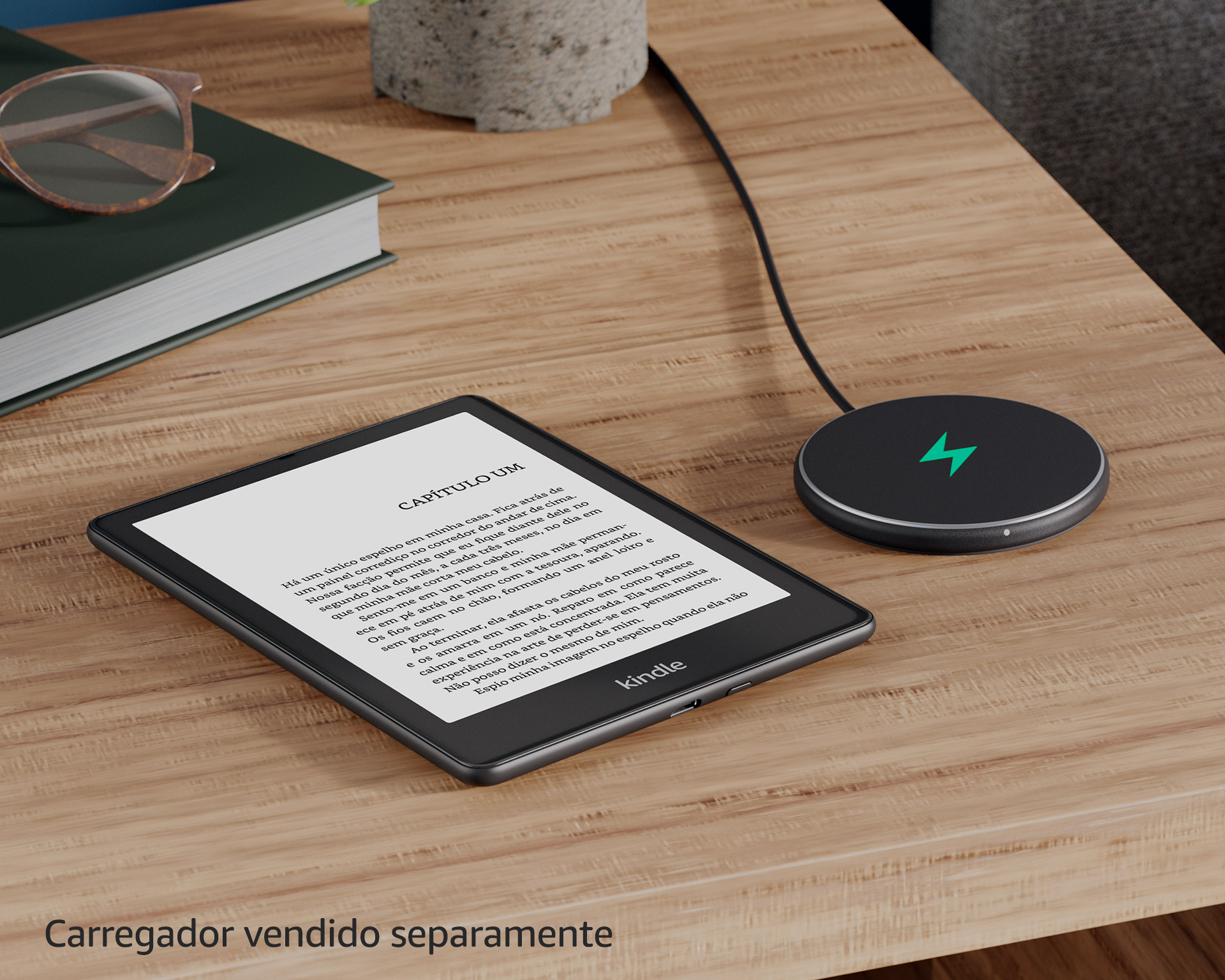 O Kindle Paperwhite Signature Edition está na base para carregamento, em uma mesa de canto.